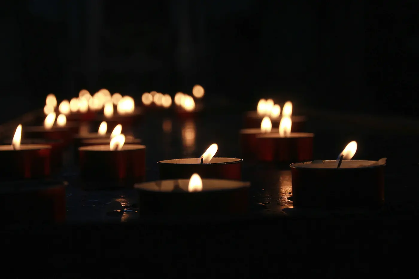 Tealight candles glowing in the quiet of the church